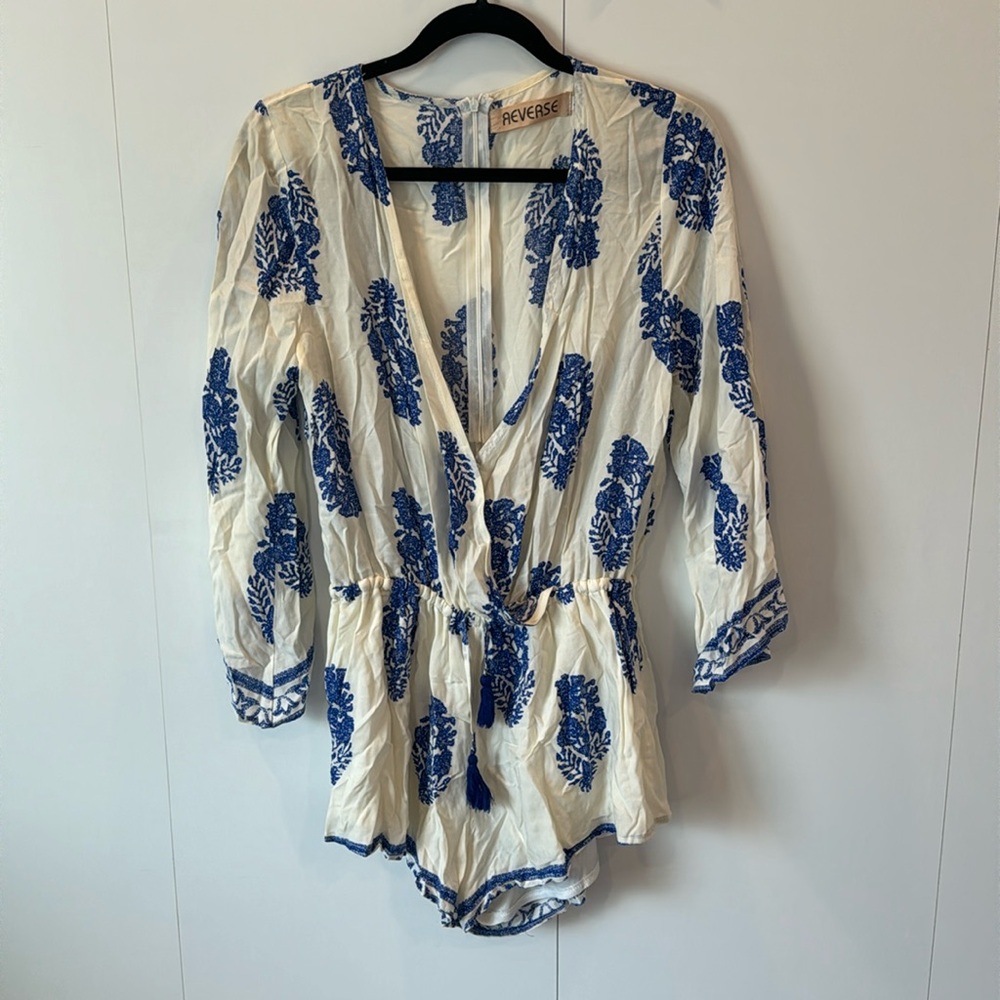 Blue and white romper with cinched waist.